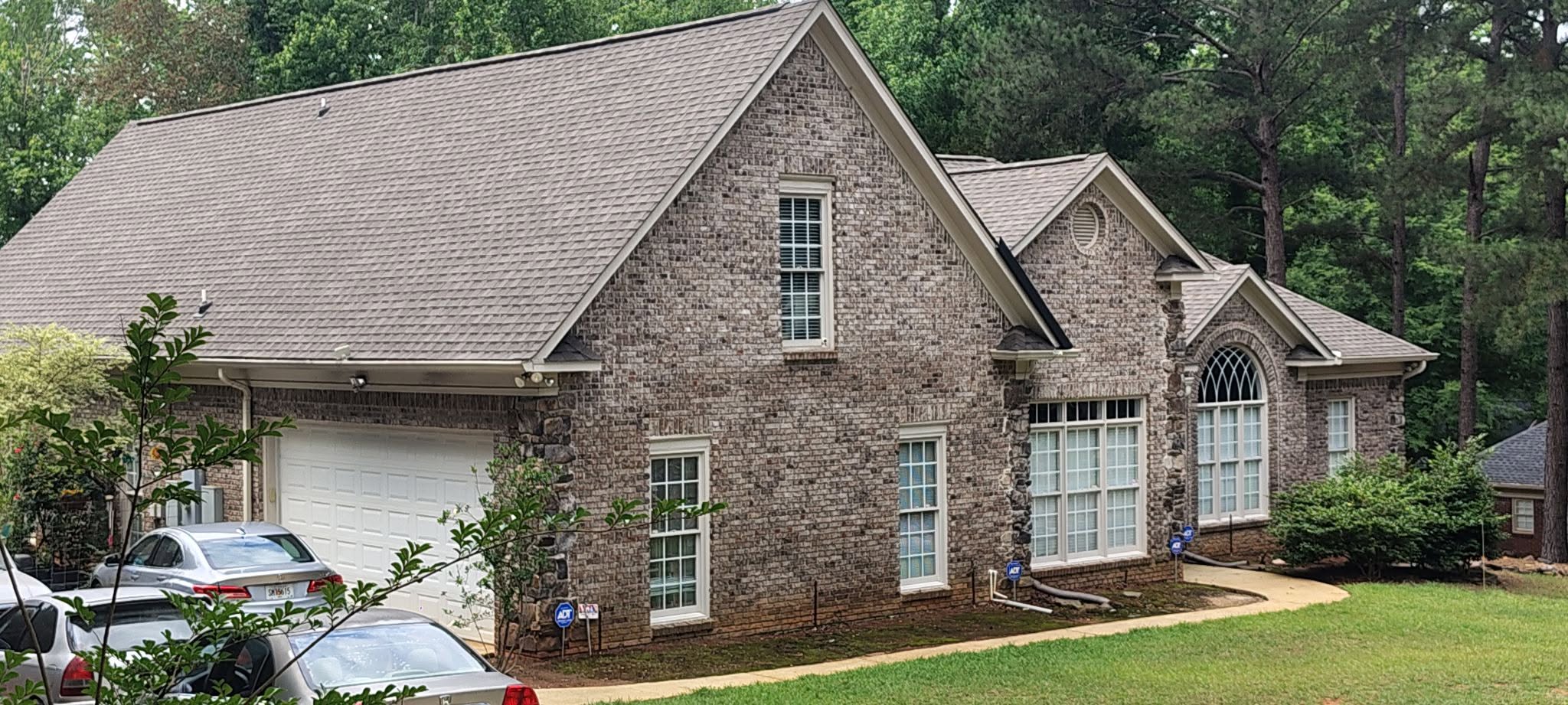 Two-story brick home with Tamko weathered wood architectural shingle roof