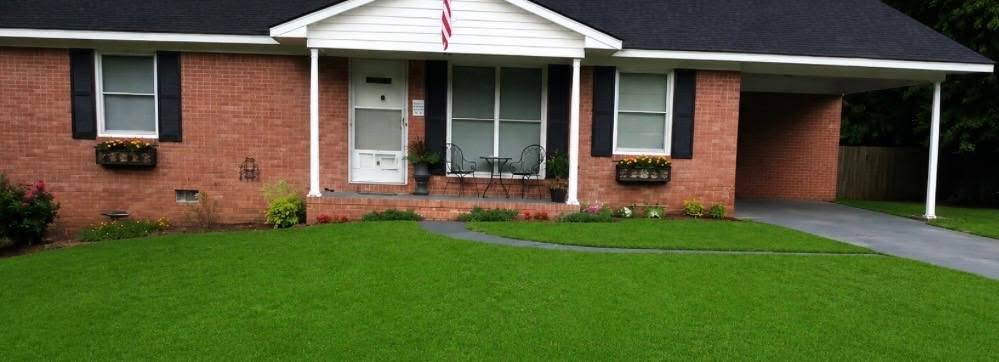 Brick ranch with new dark shingle roof and columned front porch