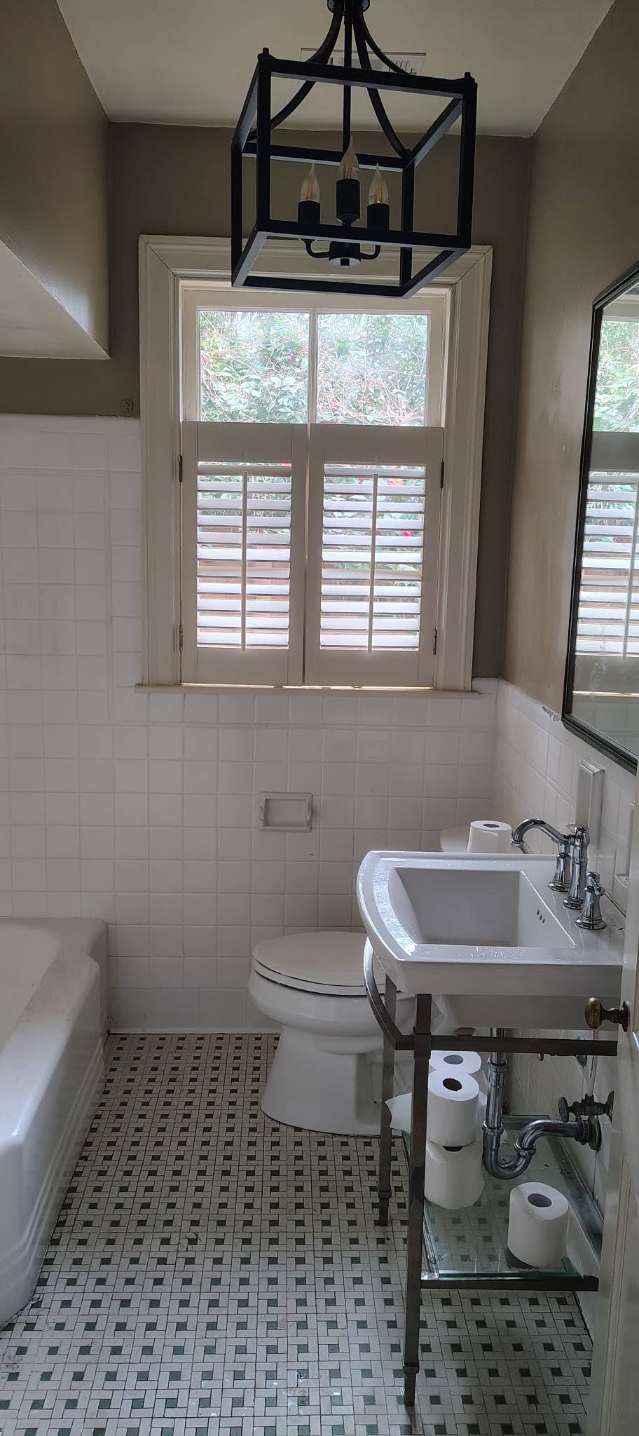 Renovated bathroom with subway tile and plantation shutters