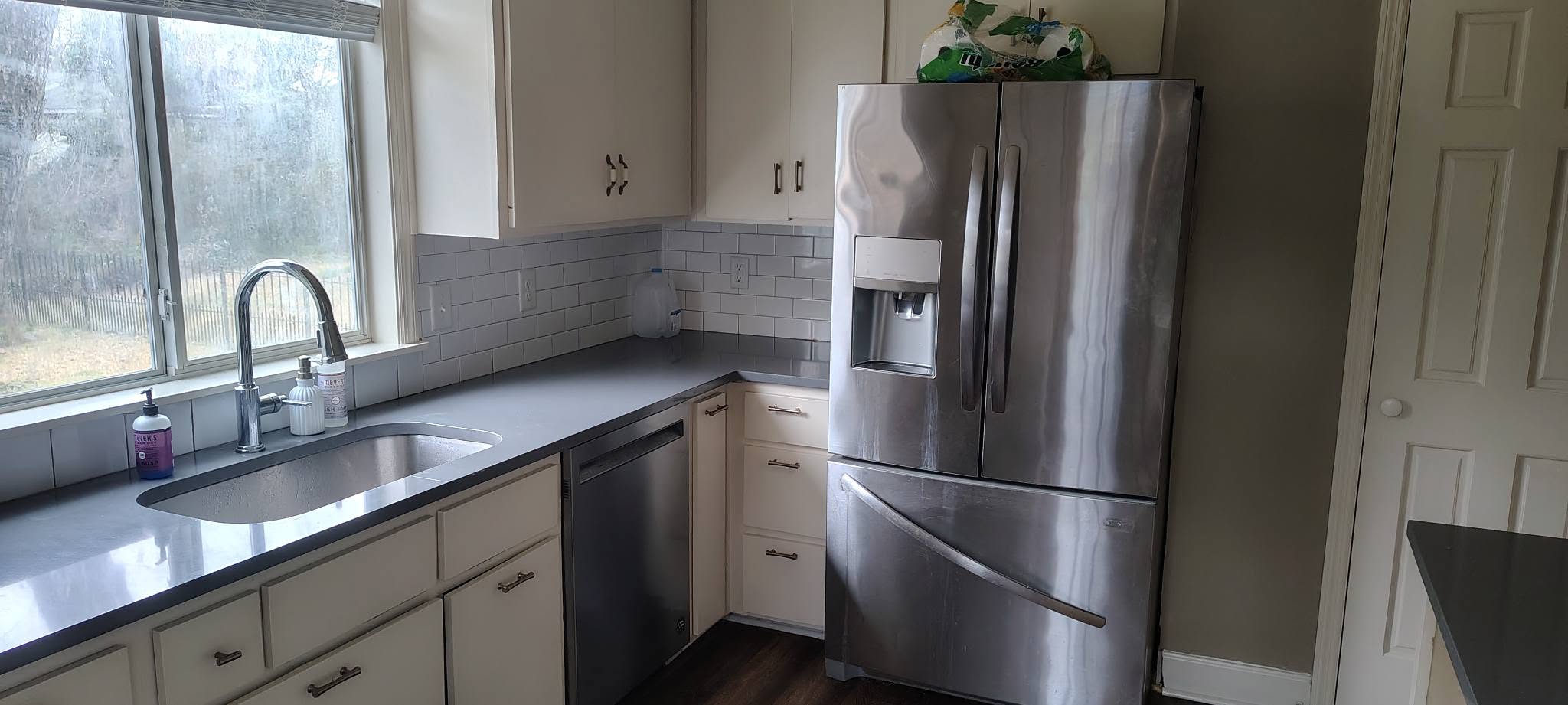 Kitchen with white cabinets and dark hardwood floor
