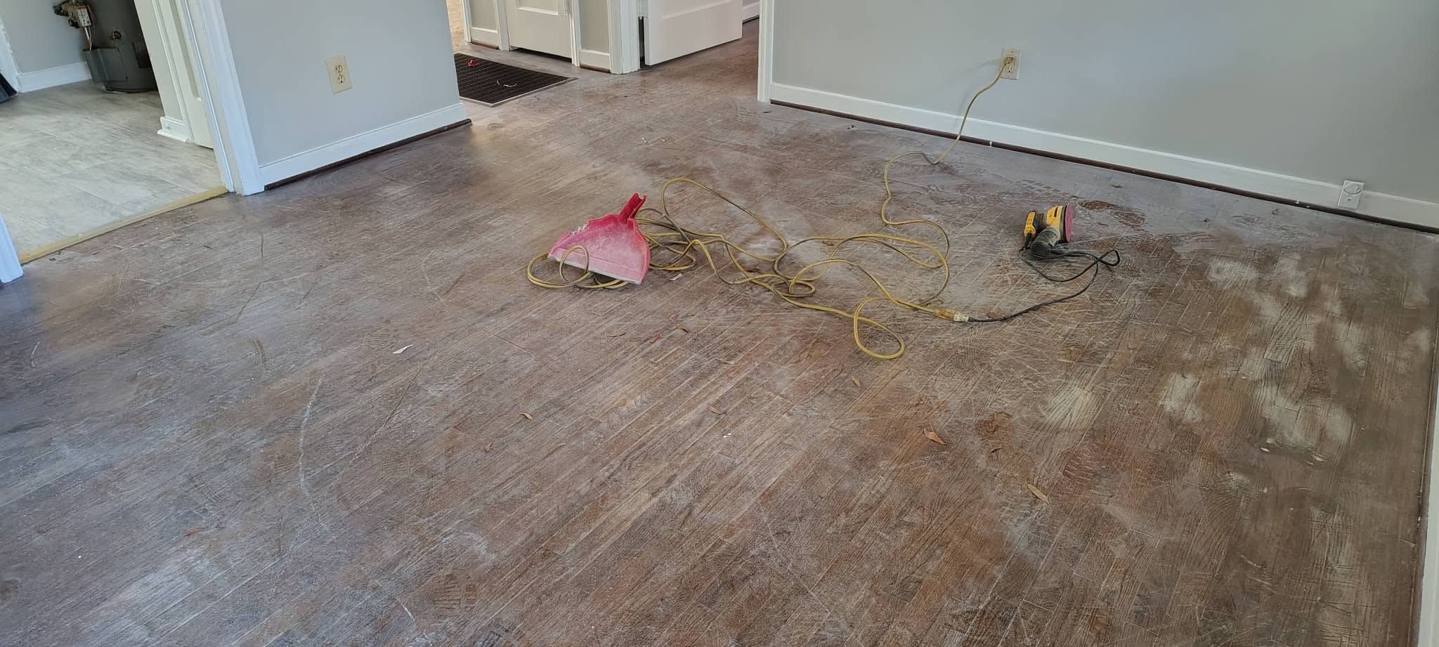 Worn wood floors mid-renovation before refinishing